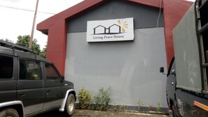 A building with a sign reading "Living Peace House." - Living Peace House (Manado)