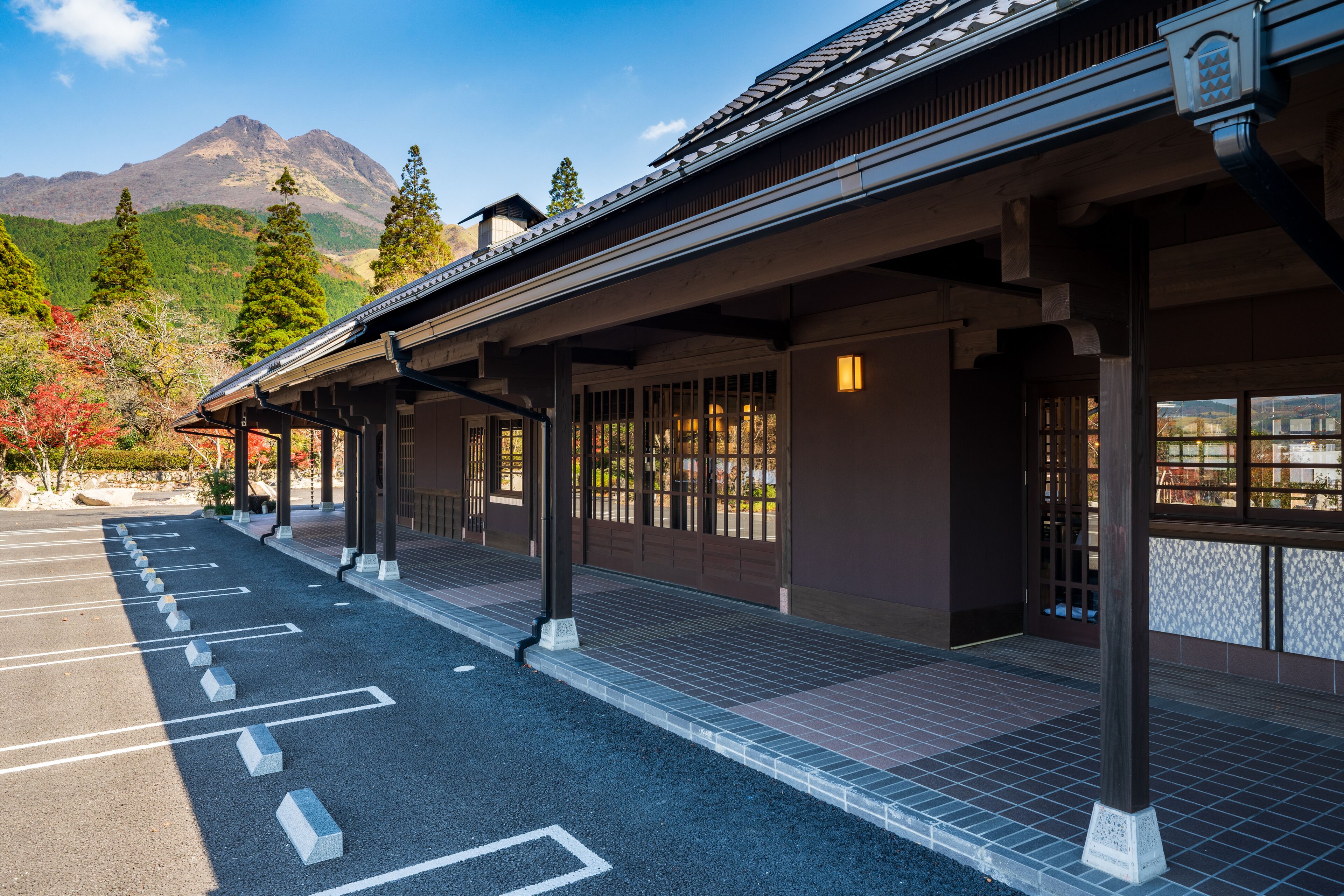 A traditional building with a covered walkway and a parking area.