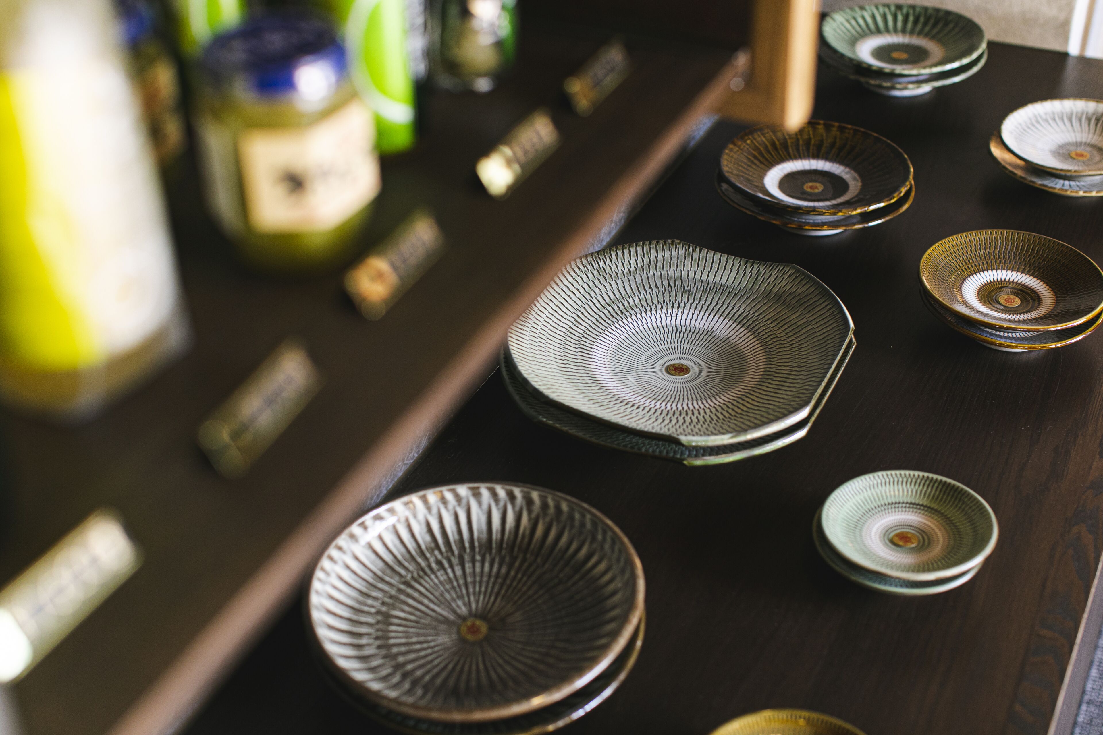 A kitchen with various ceramic plates and jars.