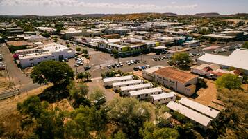 A small town with a mix of commercial and residential buildings, including a large industrial facility and several smaller shops.