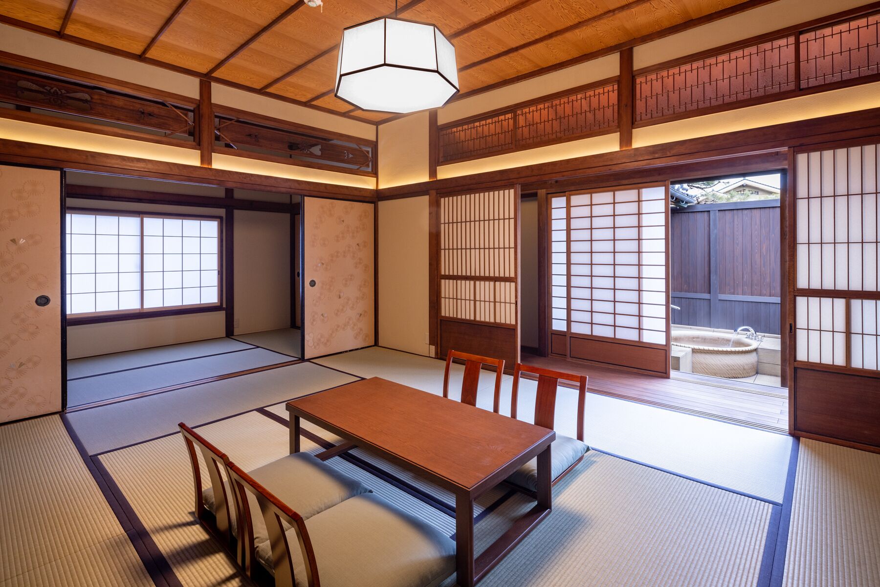 A traditional Japanese room with tatami flooring, a low wooden table, and sliding shoji doors.