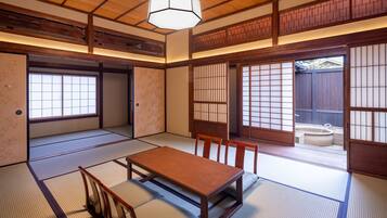A traditional Japanese room with tatami flooring, a low wooden table, and sliding shoji doors.