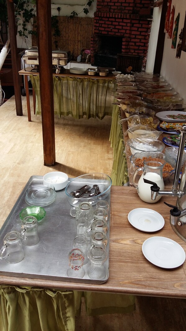 A buffet setup with various food items and utensils on a table. - Kaliptus Hotel (Kemer)