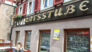 A restaurant named "Ratsstube" with a stone facade, red shutters, and outdoor seating. - Hotel Ratsstube Calw (Calw)