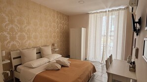 A bedroom with a bed, bedside tables, a desk, and a wardrobe. - B&B 248 (Naples)