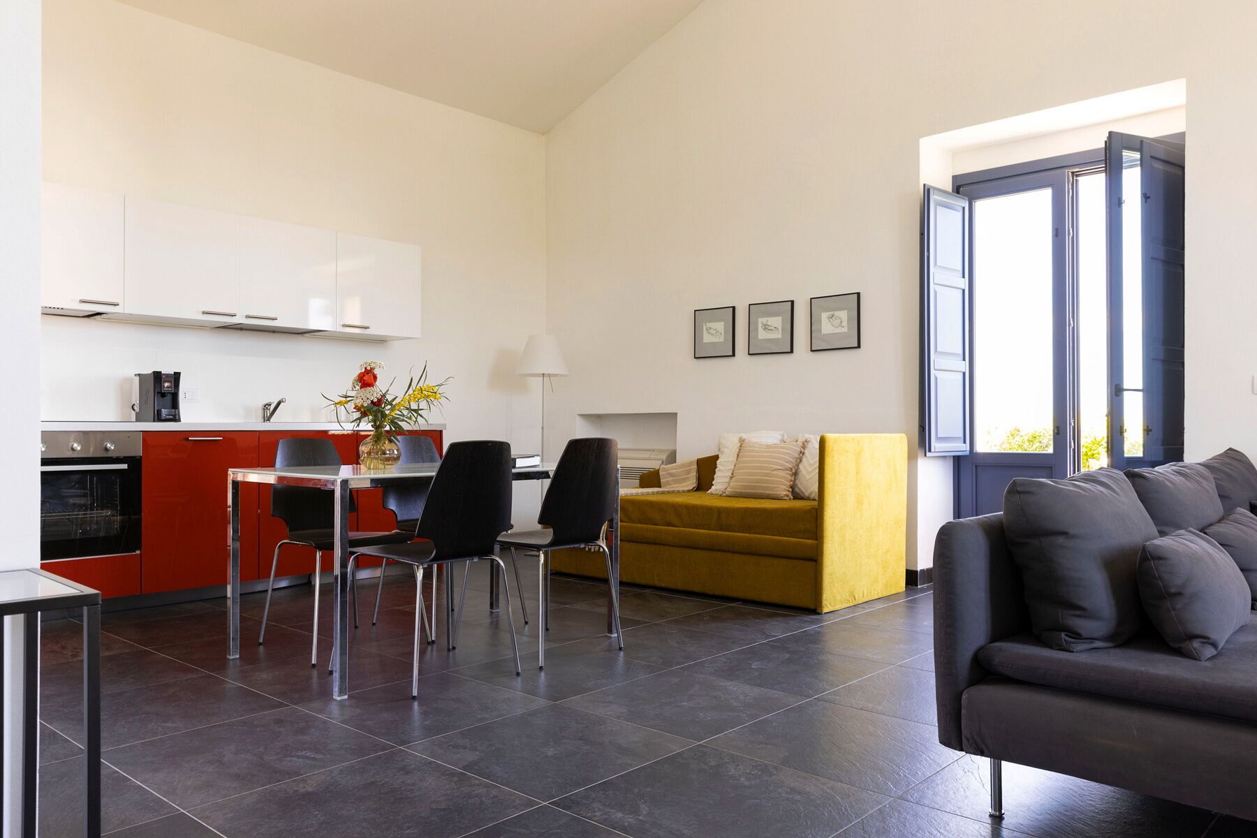 A modern living space with a kitchen, dining area, and seating area.