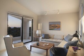 Relax in this stylish living room with a comfortable sofa, wooden coffee table, and sliding glass door leading to an outdoor area.