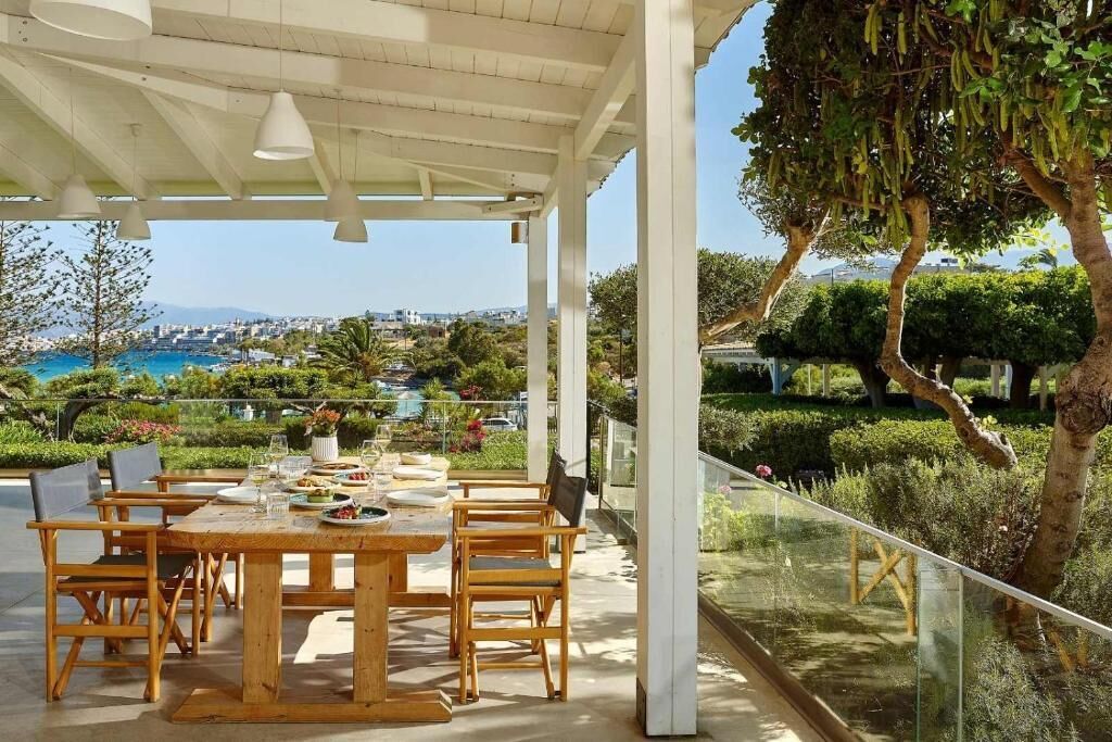 An outdoor dining area with a view of a coastal landscape.