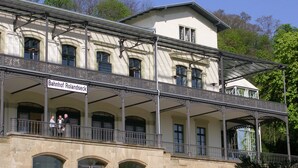 A historic building with a balcony and a sign reading "Bahnhof Rolandseck". - Hotel Pinger (Remagen)