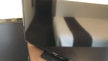 A flat-screen TV on a wooden table.