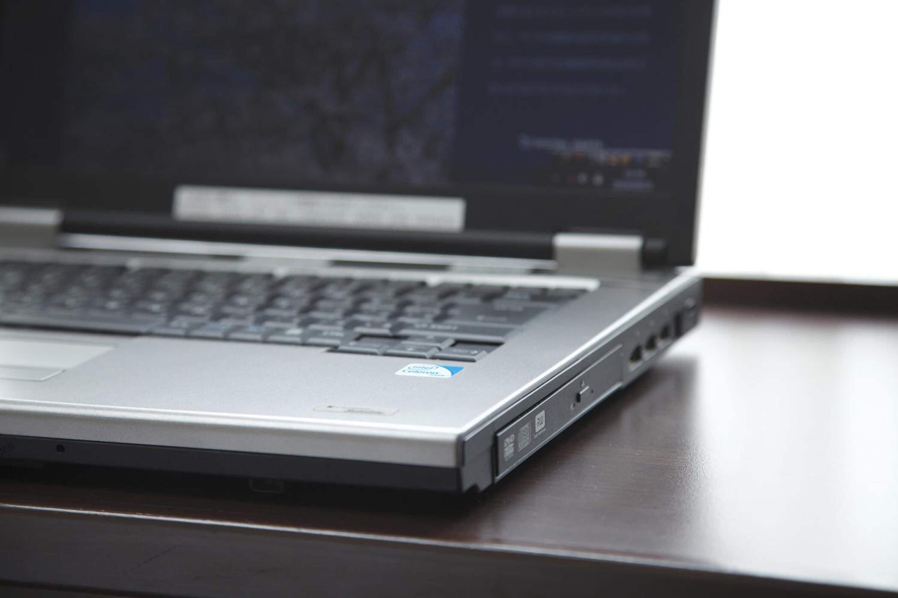 A laptop on a wooden desk.