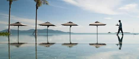 Piscine extérieure, parasols de plage, chaises longues