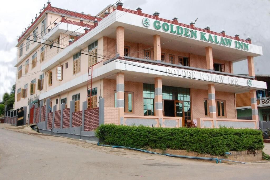 A two-story building with a sign reading "Golden Kalaw Inn."