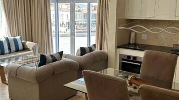 Self Catering Suite Marina view | Living area | Flat-screen TV