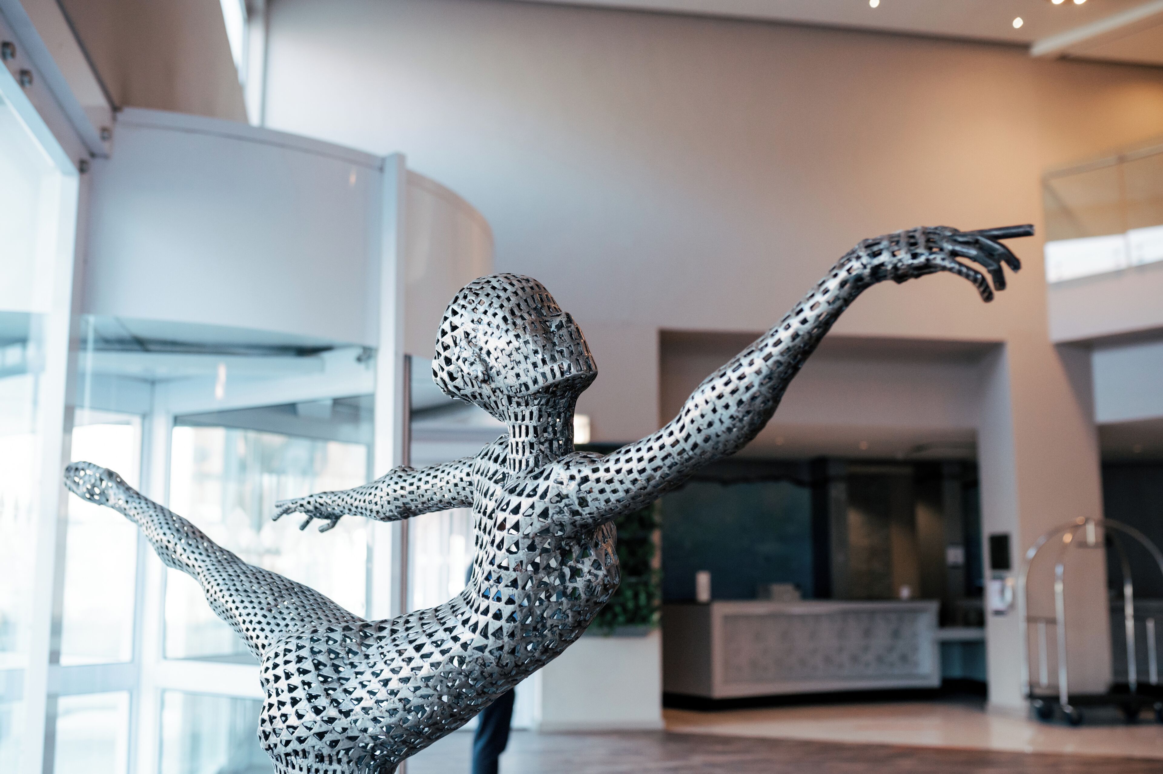 A modern sculpture in a spacious lobby with large windows and a contemporary design.