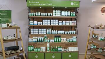 A spa product display with multiple shelves and a green sign above.