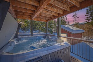 A hot tub on a wooden deck with a view of snow-covered trees and a mountain in the background. - Casa De Plata 5 Bedroom Home by RedAwning (Breckenridge)