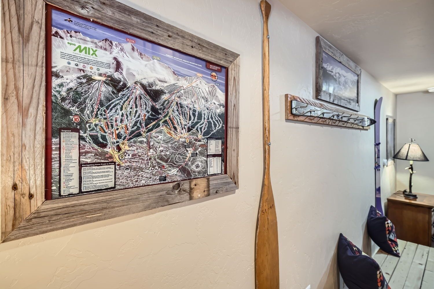 A wall with a large map, a wooden bat, and a lamp.