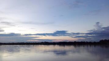A calm lake with a clear sky and a distant shoreline.