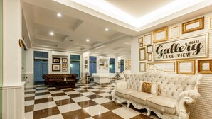 A hotel lobby with a checkered floor, a white sofa, and a wall with framed pictures and the text "Gallery Lake View Hotel". - Gallery Lake View Hotel (Khon Kaen)