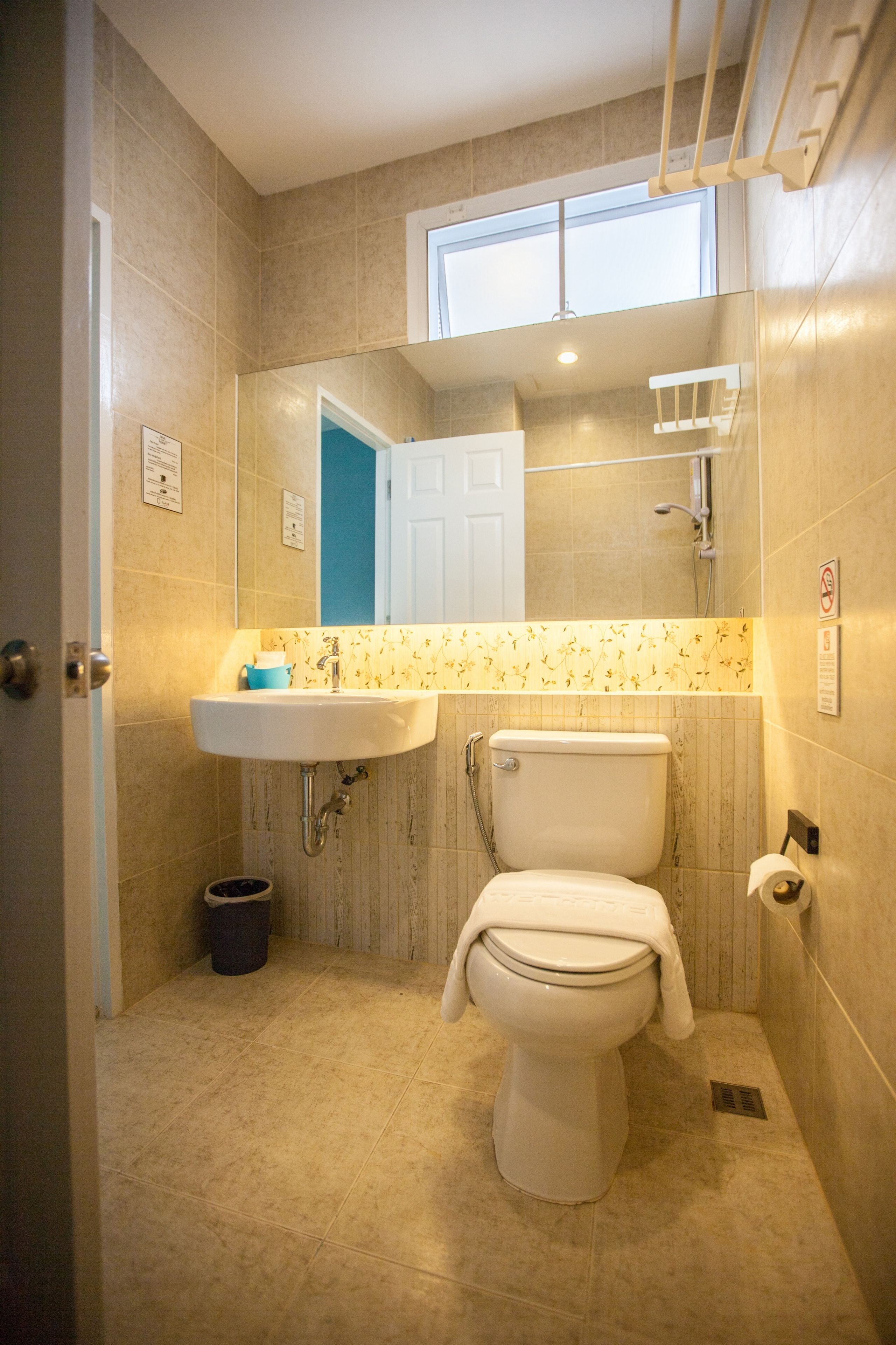A bathroom with a toilet, sink, and shower.