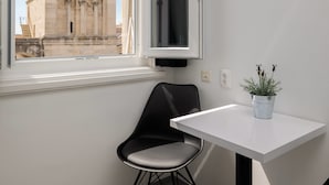 A modern room with a view of a historic building through a window. - PLR Accommodation (Split)