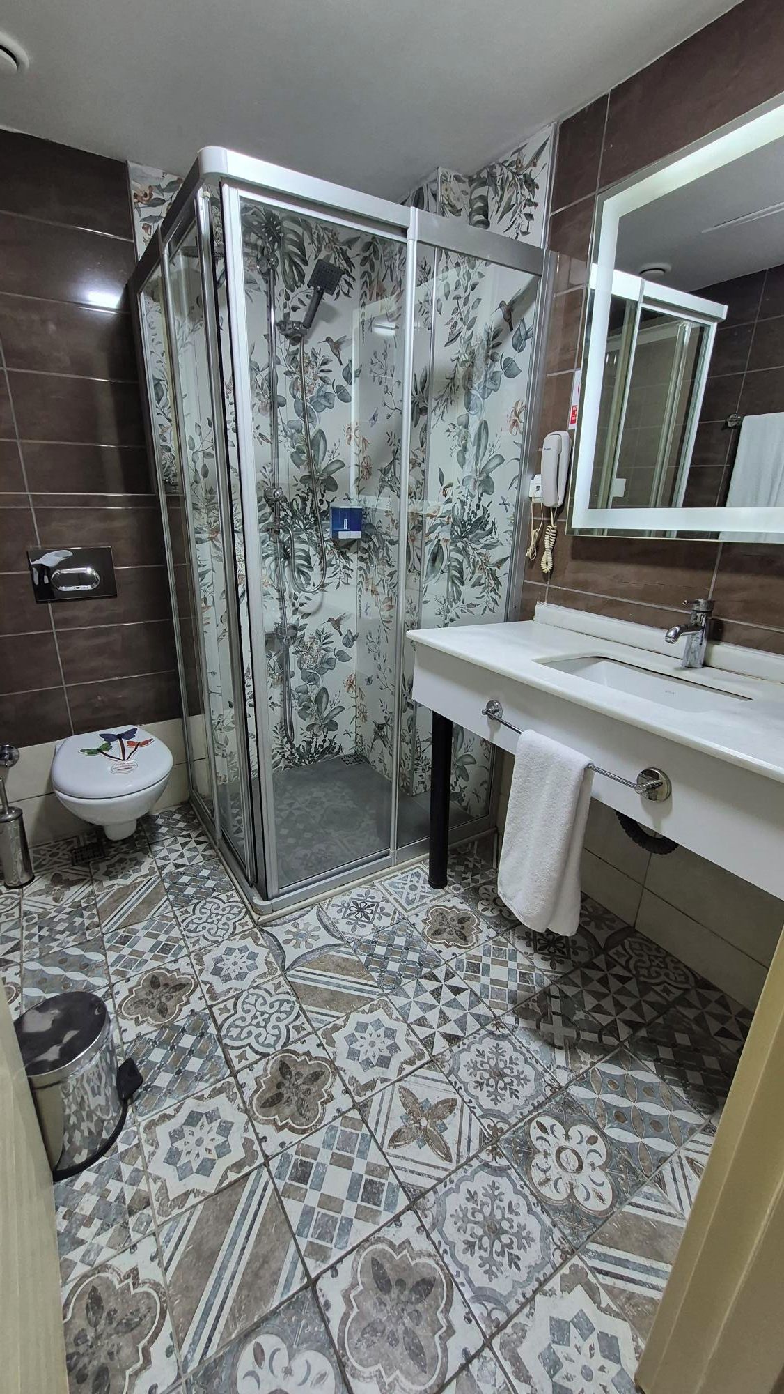 A bathroom with a shower, toilet, and sink.