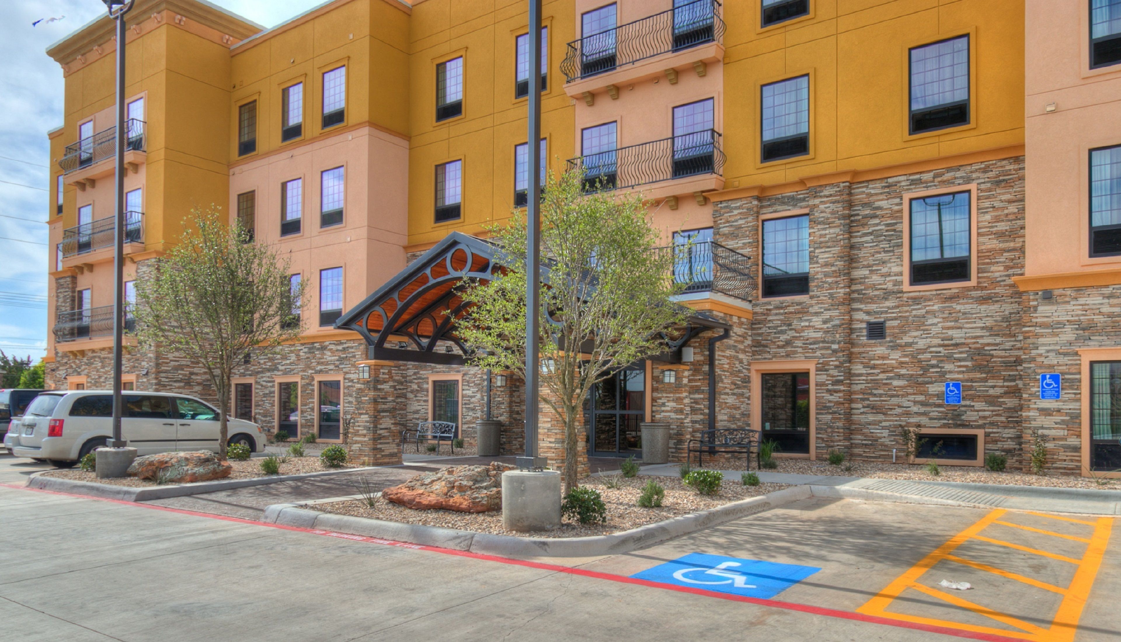 A multi-story hotel with a stone facade and balconies.