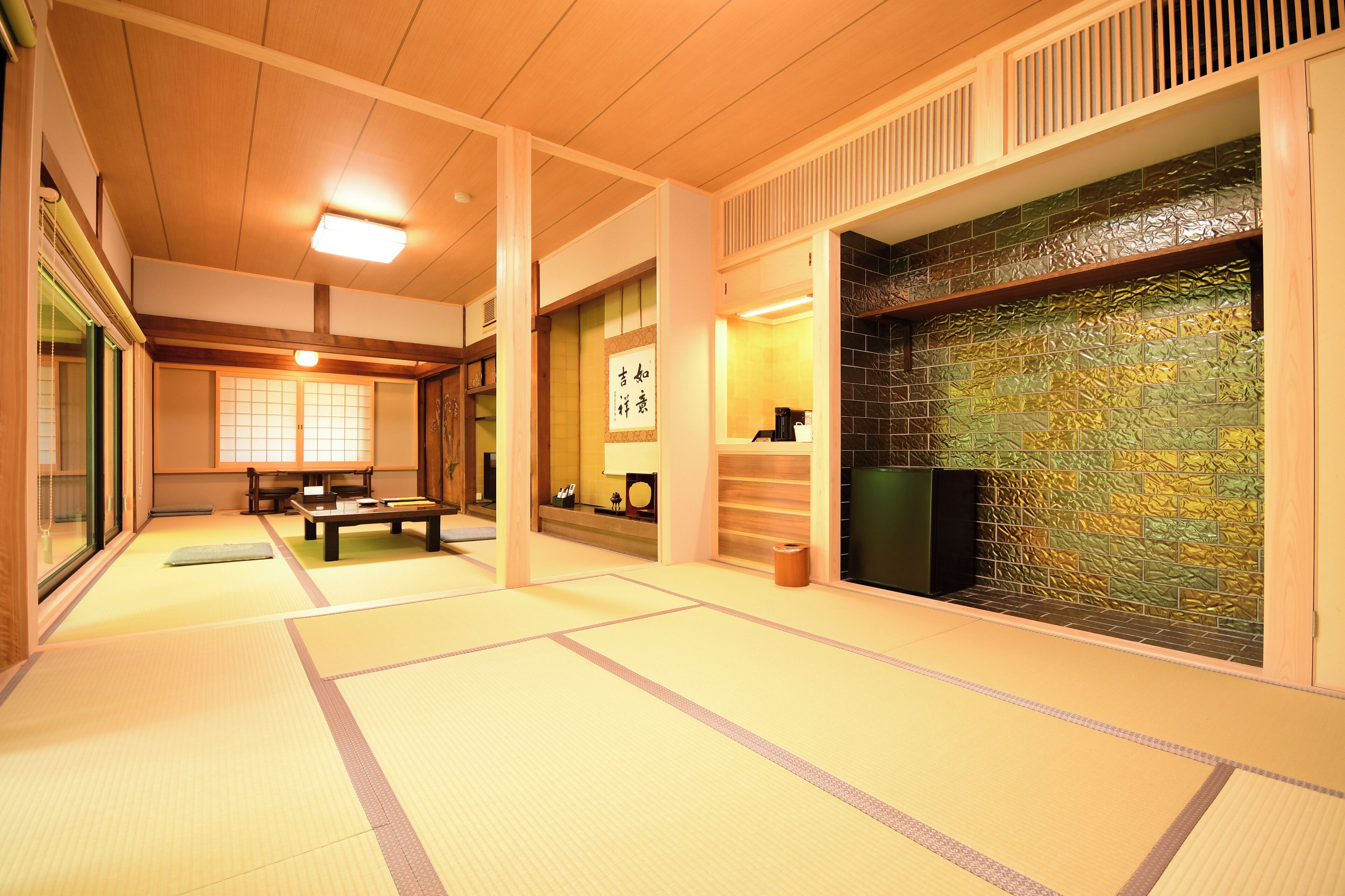 A traditional Japanese room with tatami flooring, a low wooden table, and a sliding door.