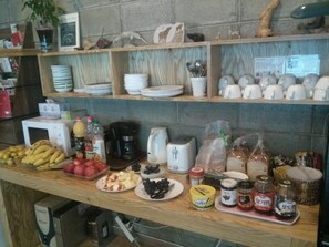 A kitchen counter with various food items, utensils, and appliances. - NeaRest Guesthouse in Jeonju - Hostel (Jeonju)