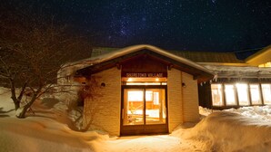 A snow-covered building with a sign reading "SHIRETOKE VILLAGE". - Shiretoko Village (Shari)