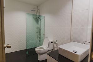 A bathroom with a toilet, a shower, and a sink. - No.9 Hostel (Chiang Mai)