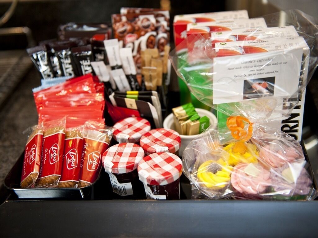 A variety of packaged food items, including snacks and condiments, displayed in a retail setting.