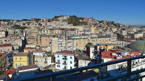 A densely packed urban area with a variety of building styles and a prominent dome structure. - Nel Cuore di Parthenope (Naples)