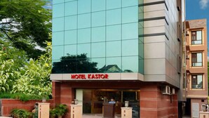A modern hotel building with a prominent sign reading "HOTEL KASTOR". - Kastor International (New Delhi)