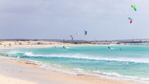 A beach with clear turquoise waters and a sandy shore. - Cala Da Lua (Boa Vista)