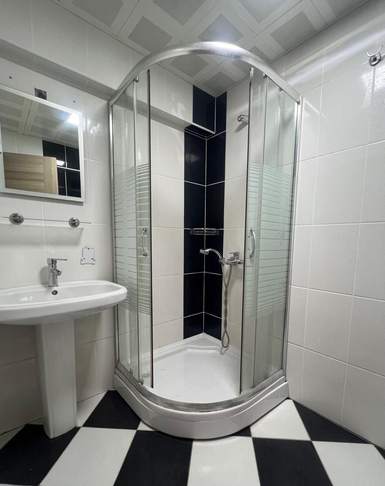 shower, hair dryer, slippers, towels