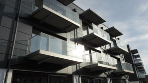 A modern building with multiple balconies and large windows. - Hotel Aurelia (Aldingen)