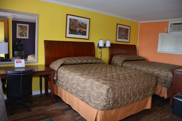 A hotel room with two beds, a desk, and a chair. - Harmony Inn (Goderich)