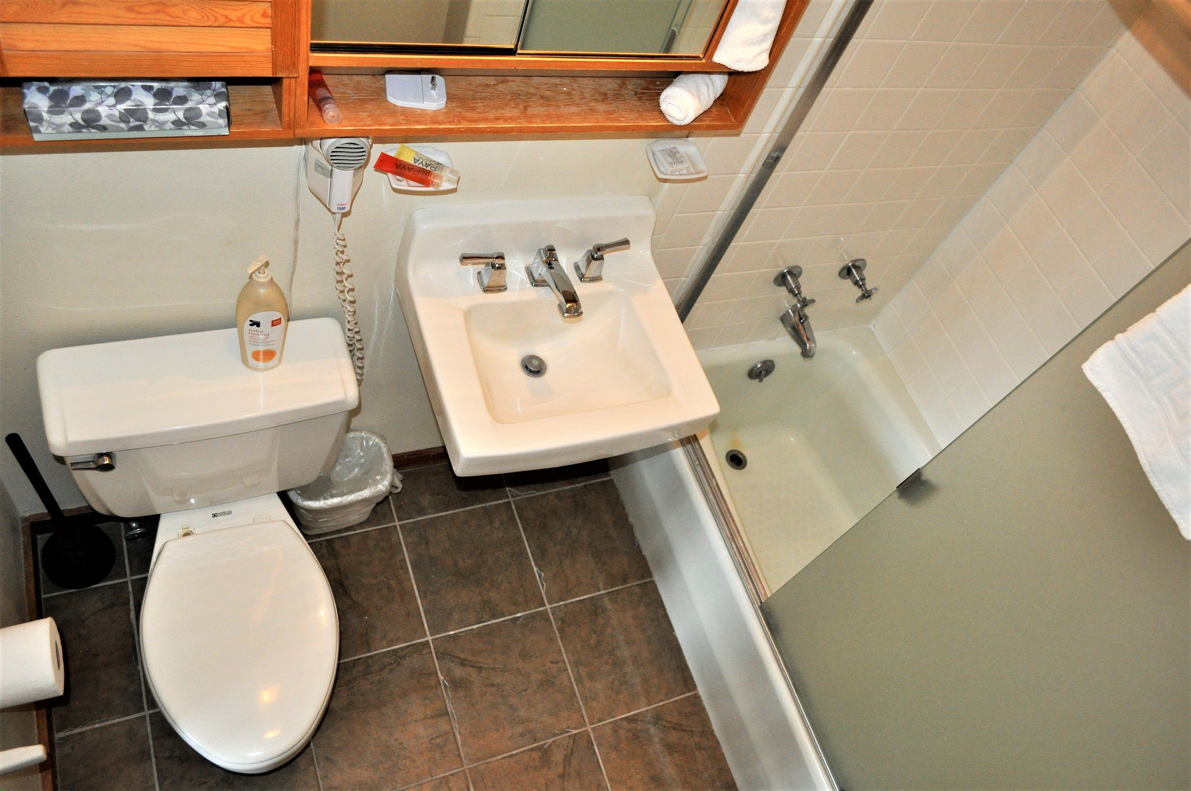 A bathroom with a toilet, sink, and bathtub.