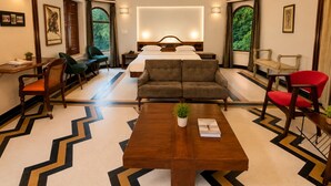 A hotel room with a bed, two sofas, a dining table, and a coffee table. - Hotel Inn Season - A Heritage Hotel in Jodhpur (Jodhpur)