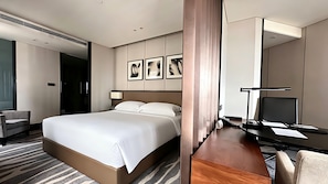 A hotel room with a large bed, a desk with a chair, a TV, and framed artwork on the wall. - InterContinental Shanghai Hongqiao NECC by IHG (Shanghai)