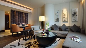 A modern hotel lobby with a dining area, a sofa, and a coffee table. - InterContinental Shanghai Hongqiao NECC by IHG (Shanghai)