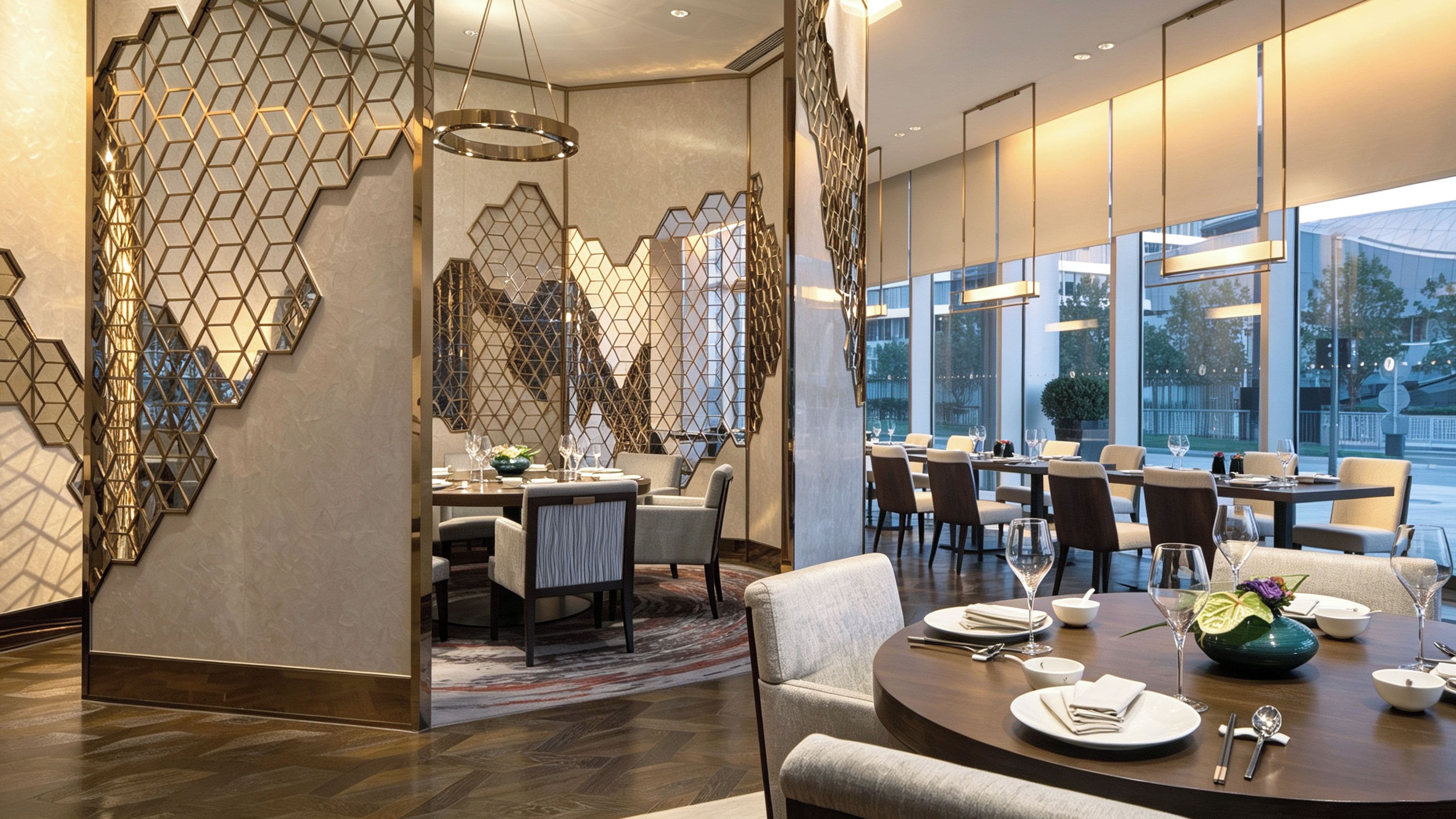A modern dining area with geometric wall designs, a variety of seating options, and a view through large windows.