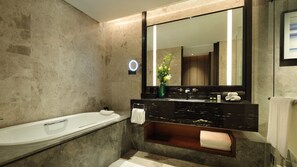 A modern bathroom with a bathtub, a vanity with a mirror, and a toilet. - InterContinental Shanghai Hongqiao NECC by IHG (Shanghai)