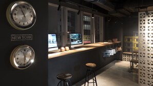 A modern bar area with clocks labeled 'LONDON' and 'NEW YORK', a counter with monitors, stools, and a decorative partition. - Attitude On Granville (Kowloon)