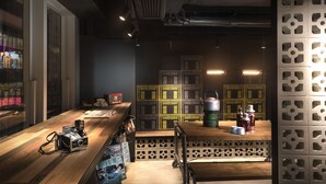 A modern kitchen with wooden countertops, a vintage camera, and a decorative wall with geometric patterns. - Attitude On Granville (Kowloon)