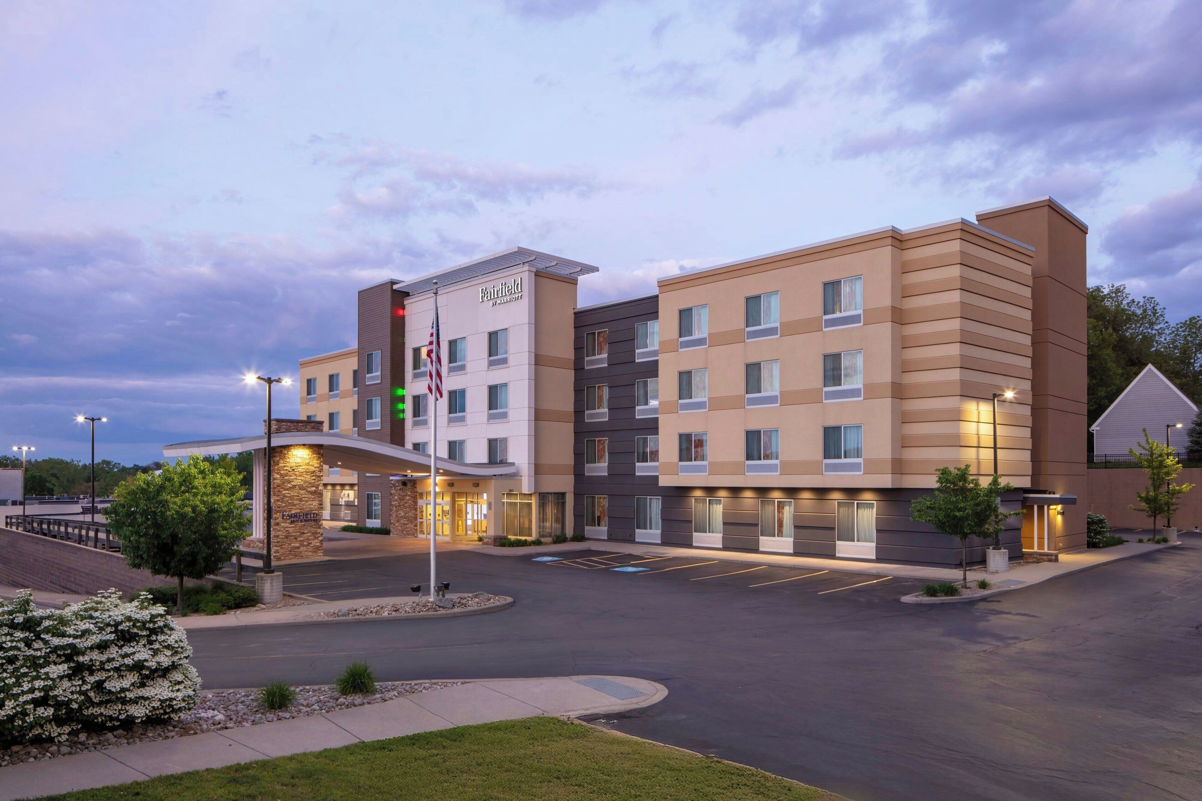 A hotel with a modern design, featuring multiple floors and a central entrance.