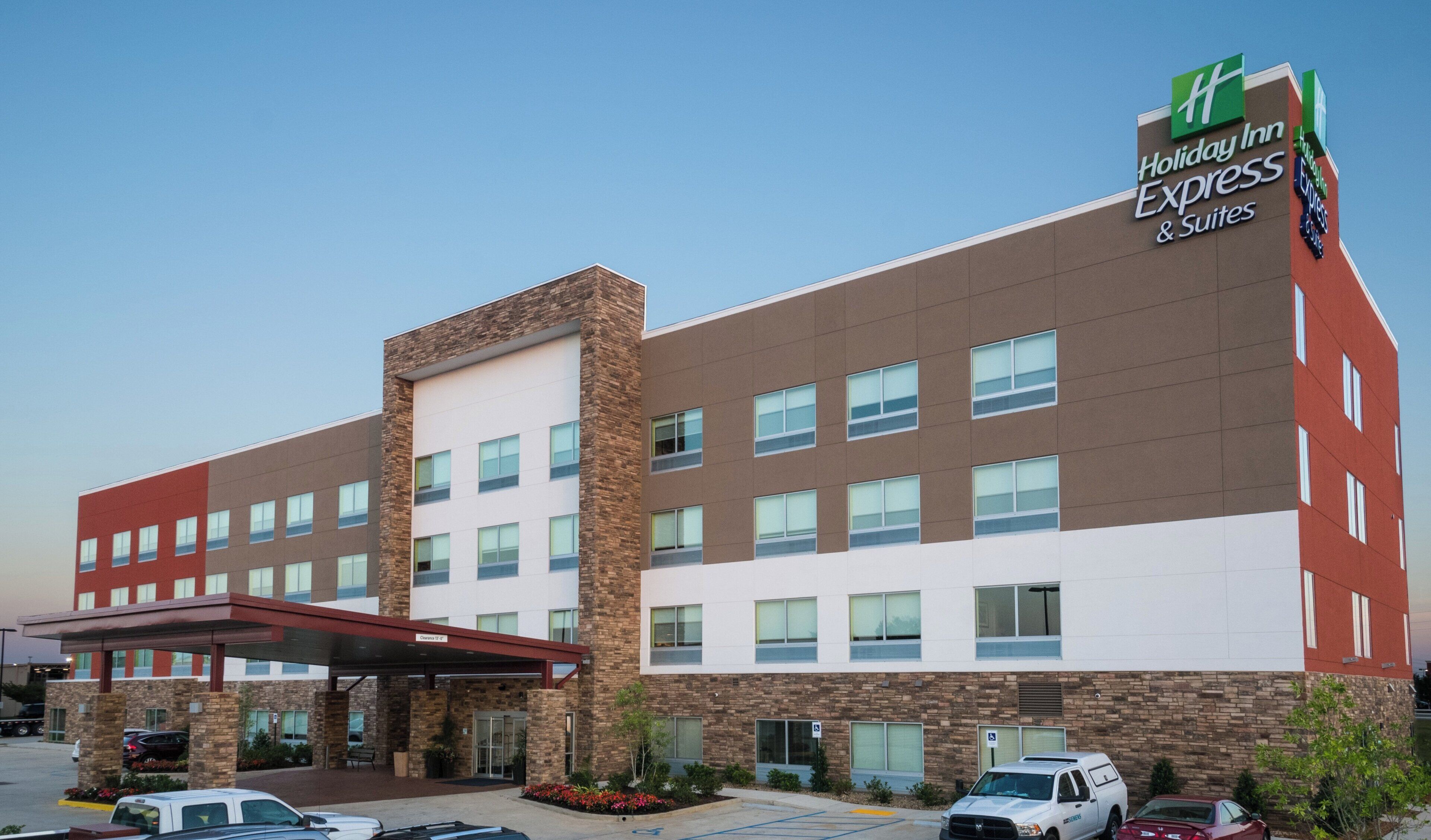 A Holiday Inn Express building with a brick facade, multiple windows, and a covered entrance.