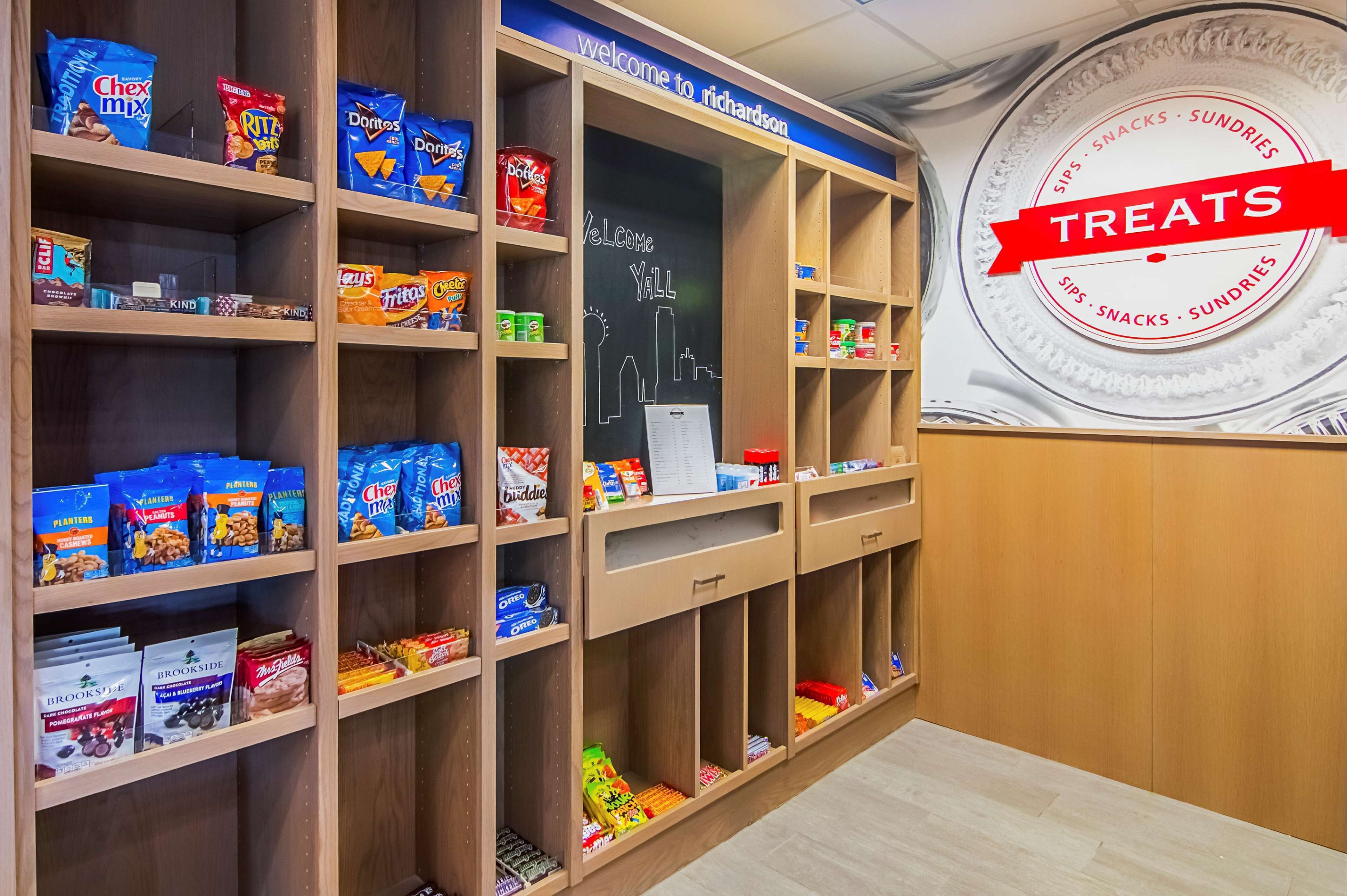 A snack display with various brands like Chex Mix, Doritos, and Lay's.